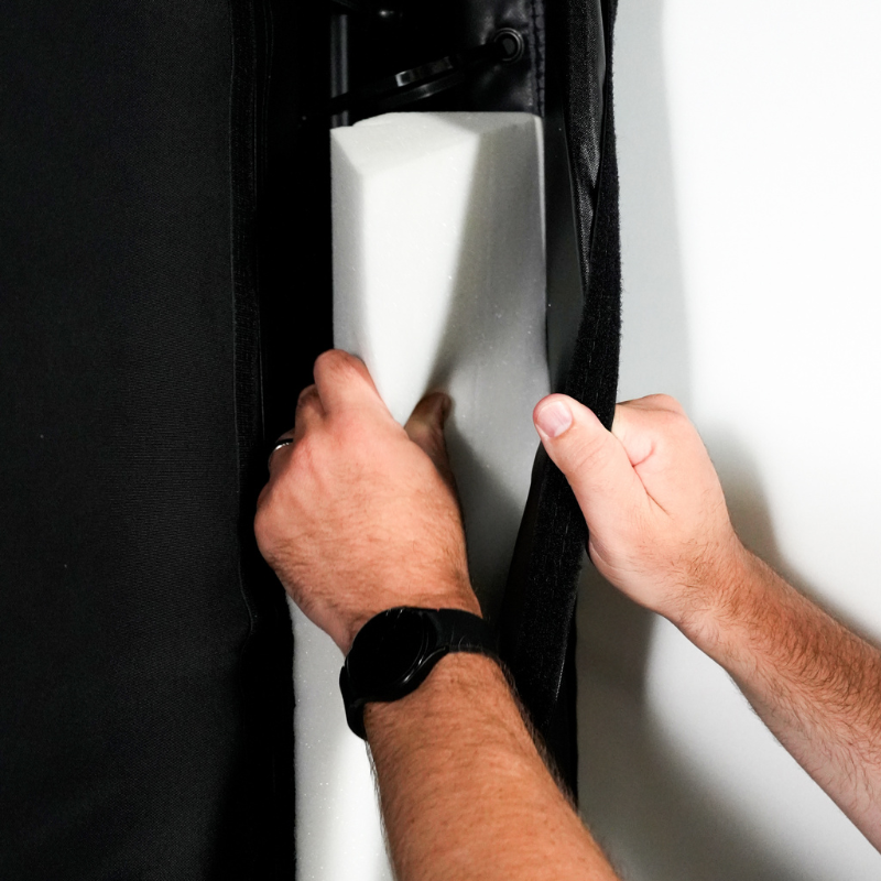 Carl's Place Foam Insert Kit being installed on a DIY Golf Simulator Enclosure Kit.